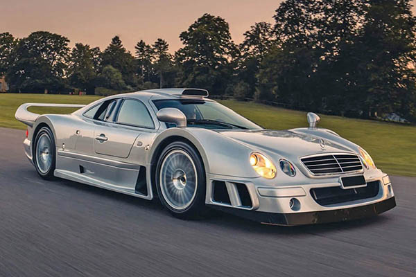 Metallic Silver 1999 Mercedes Benz Clk Gt with tree and grass backdrop