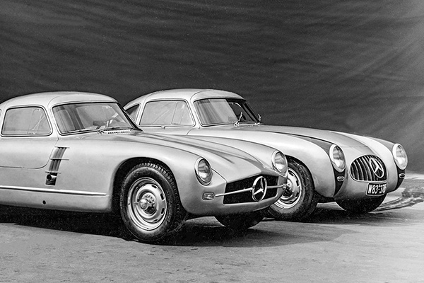 monochrome photo of 2 parked 1952 mercedes benz 300s racing cars