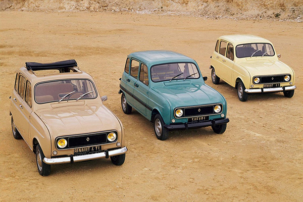 Beige soft top, teal and pale yellow Renault 5s on sand