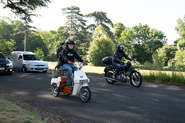 Senior man on a BSA Ariel 3 a 3 wheeled scooter