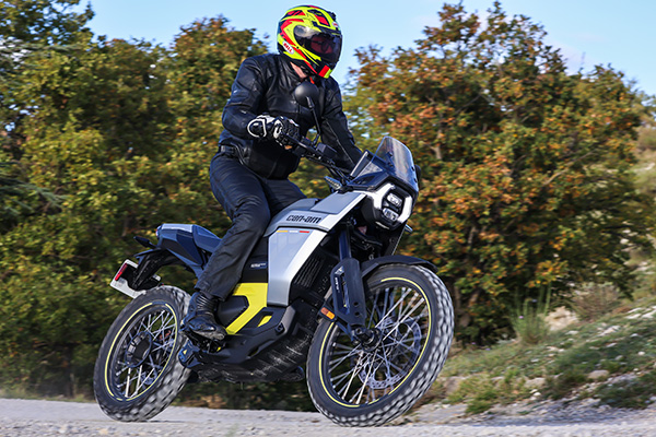 2025 Can Am Origin Rider Standing Tree Vegetation And Rock Backdrop