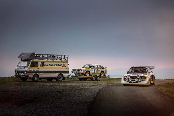 1985 Ixo Volkswagen Lt45 Swb Hb Audi Team Rally Assistance Van Carrying A Audi Sport Quattro Rally Car On Grass And Gravel Beside Another On Tarmac