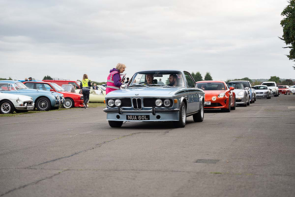 Powder Blue Early 70S BMW At Head Of Queue To Park