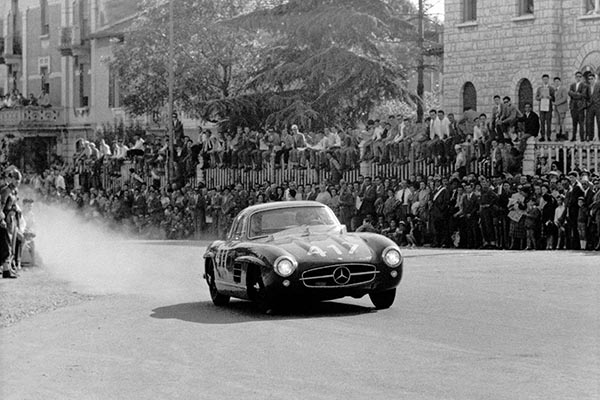 Monochrome photo of Mercedes Benz 300SL racing at Mille Miglia