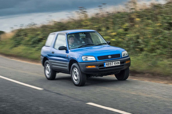 Blue Toyota RAV-4 driving on a country road