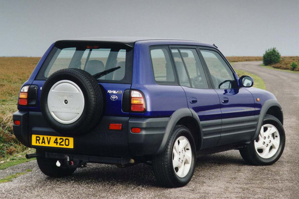 Blue Toyota Rav Jeep parked on a winding country road