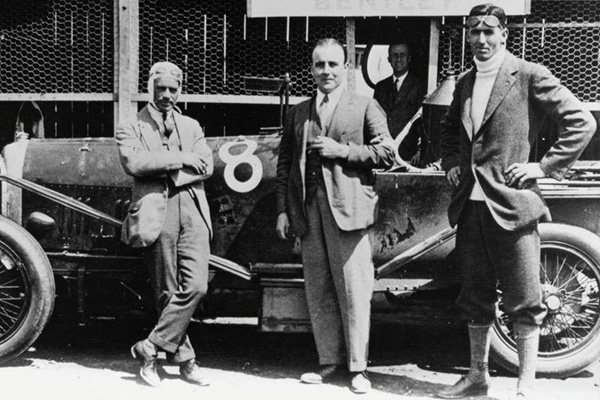 Frank Clement And John Duff Standing Beside A Racing Car On Racing Track