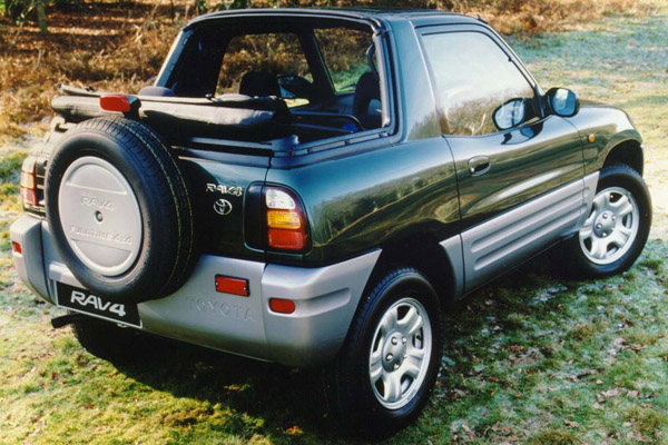 A green Toyota Rav parked on grass