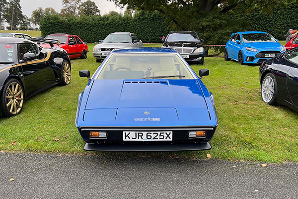 Early 80s blue Lotus Espirit Turbo on grass at Chateau Impney